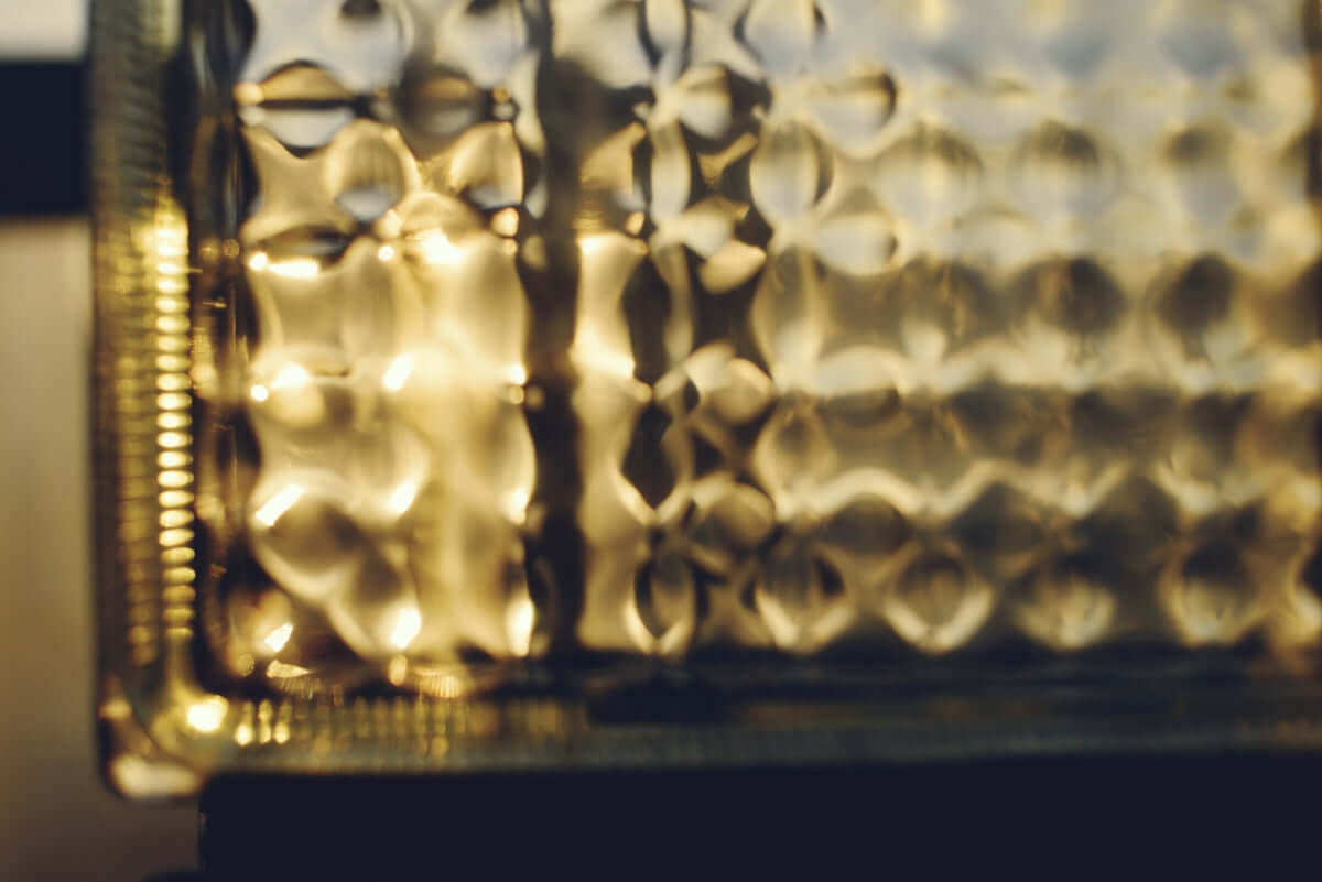 Textured glass with golden light reflection